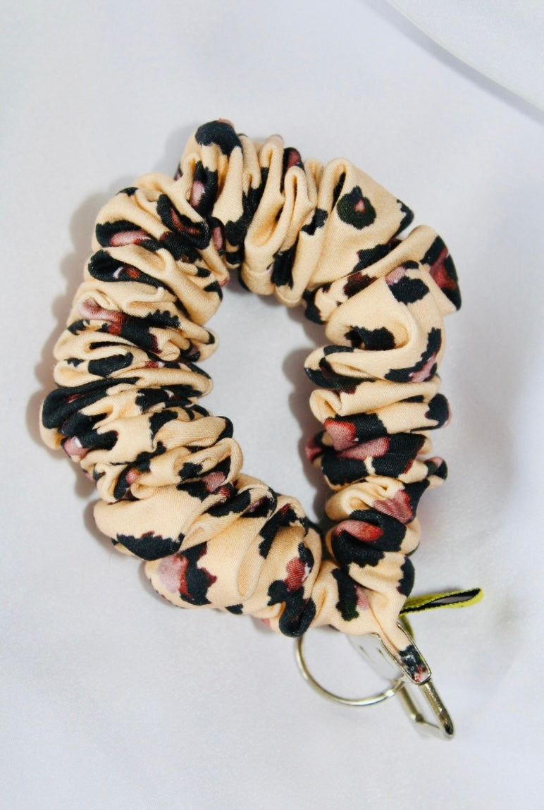 This is a cream and brown leopard print cotton scrunchie that is a keyring. Ensuring your keys are always to hand.