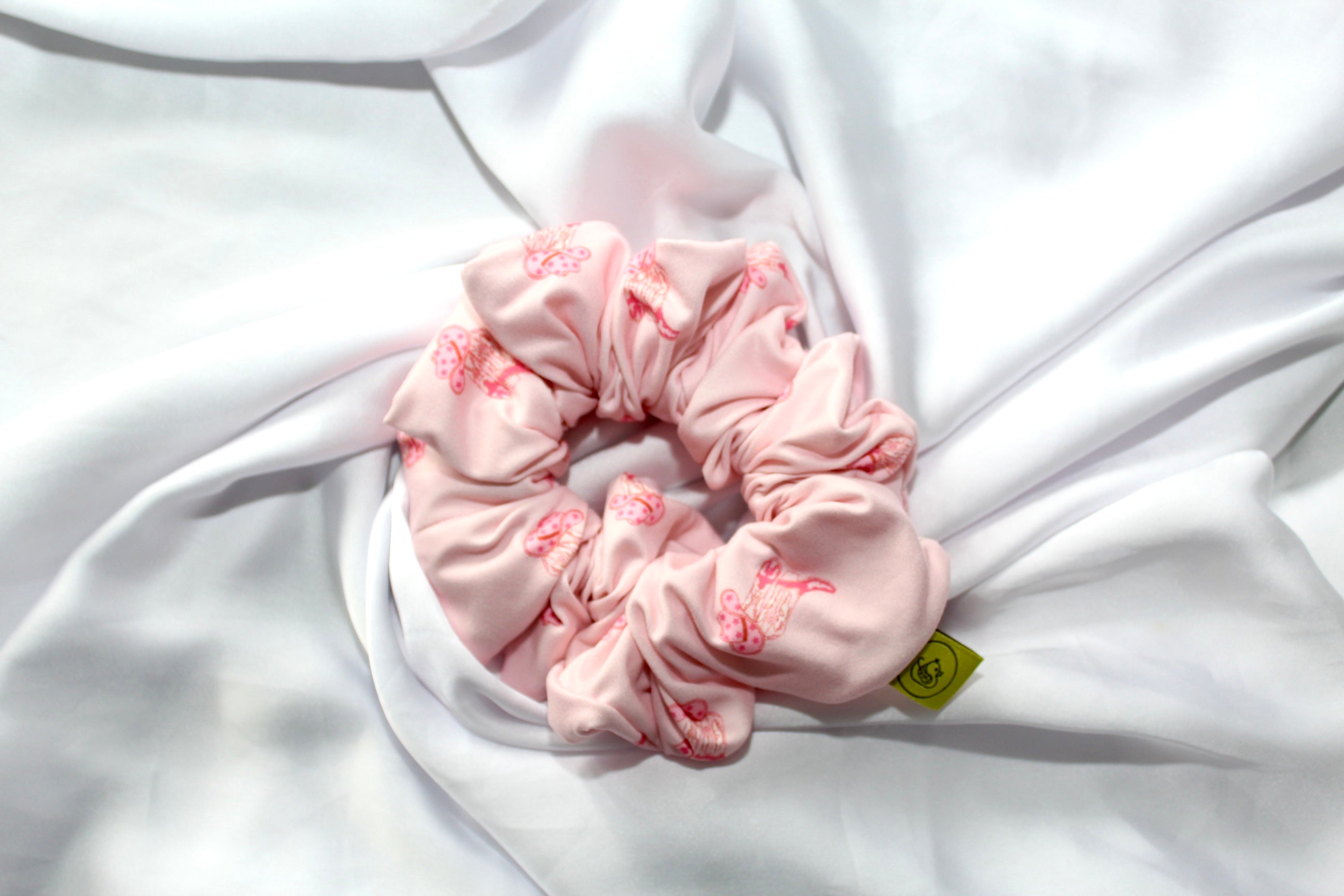 XL Pink hair scrunchie with cowgirl boots and hats on a white fabric background