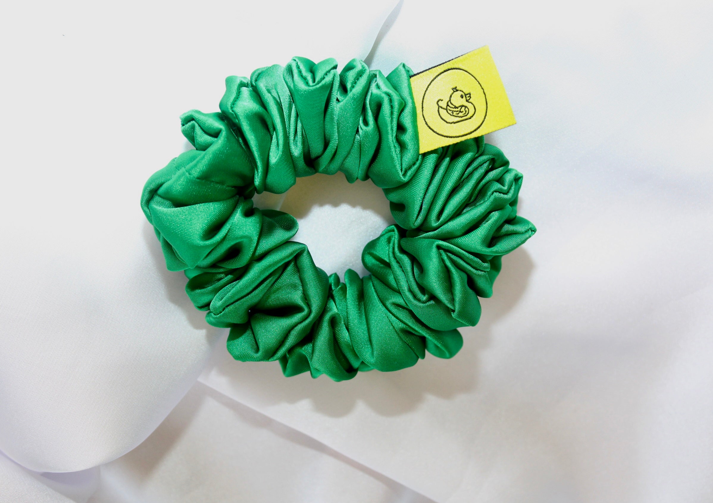 This is a luxurious Emerald Green satin hair scrunchie they are perfect for any elegant hairstyle,they will hold your hair in place without pulling on your roots preventing hair loss.Making them perfect for anyone who has a sensitive scalp or chronic illness.