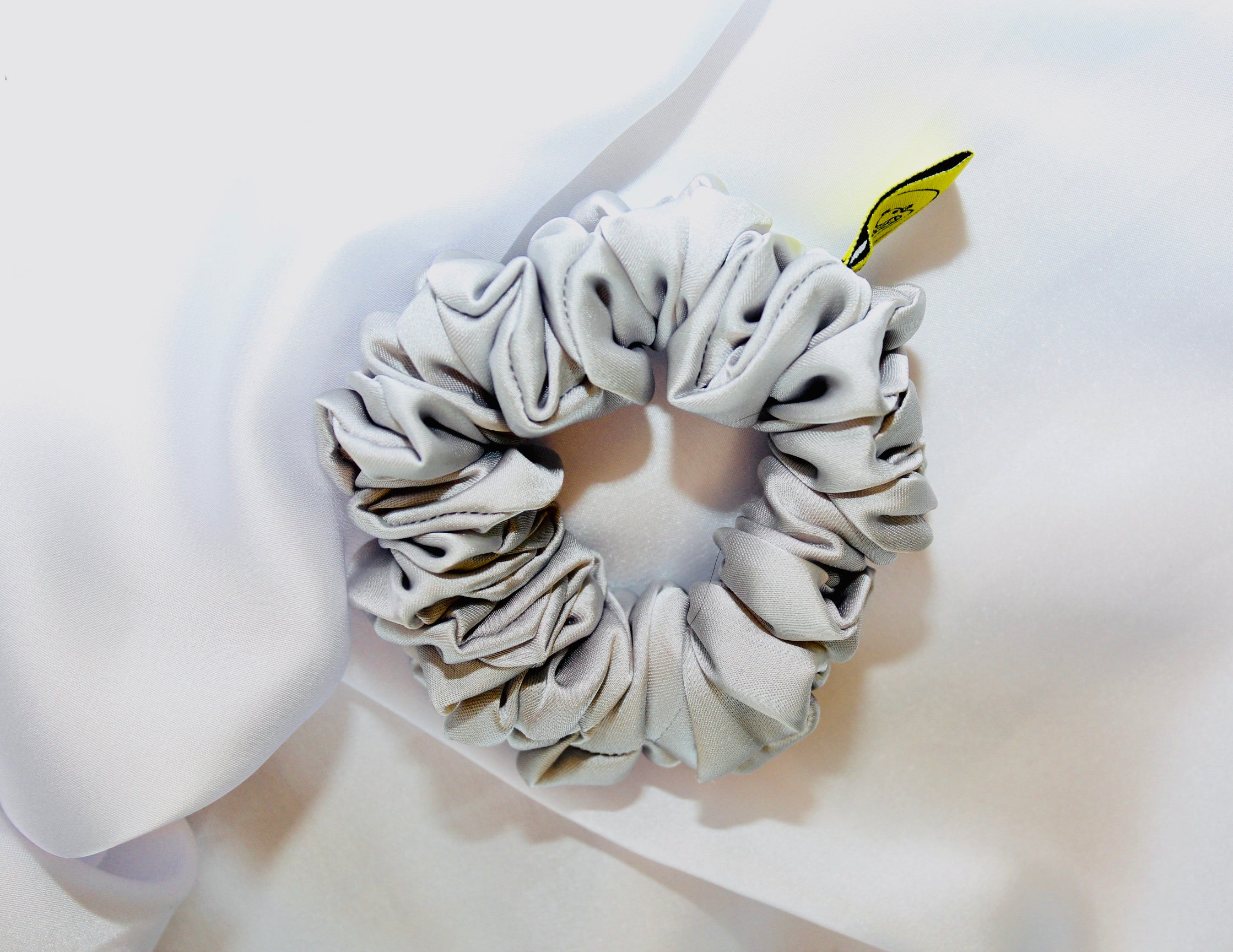 This is a luxurious Silver satin hair scrunchie they are perfect for any elegant hairstyle,they will hold your hair in place without pulling on your roots preventing hair loss.Making them perfect for anyone who has a sensitive scalp or chronic illness.