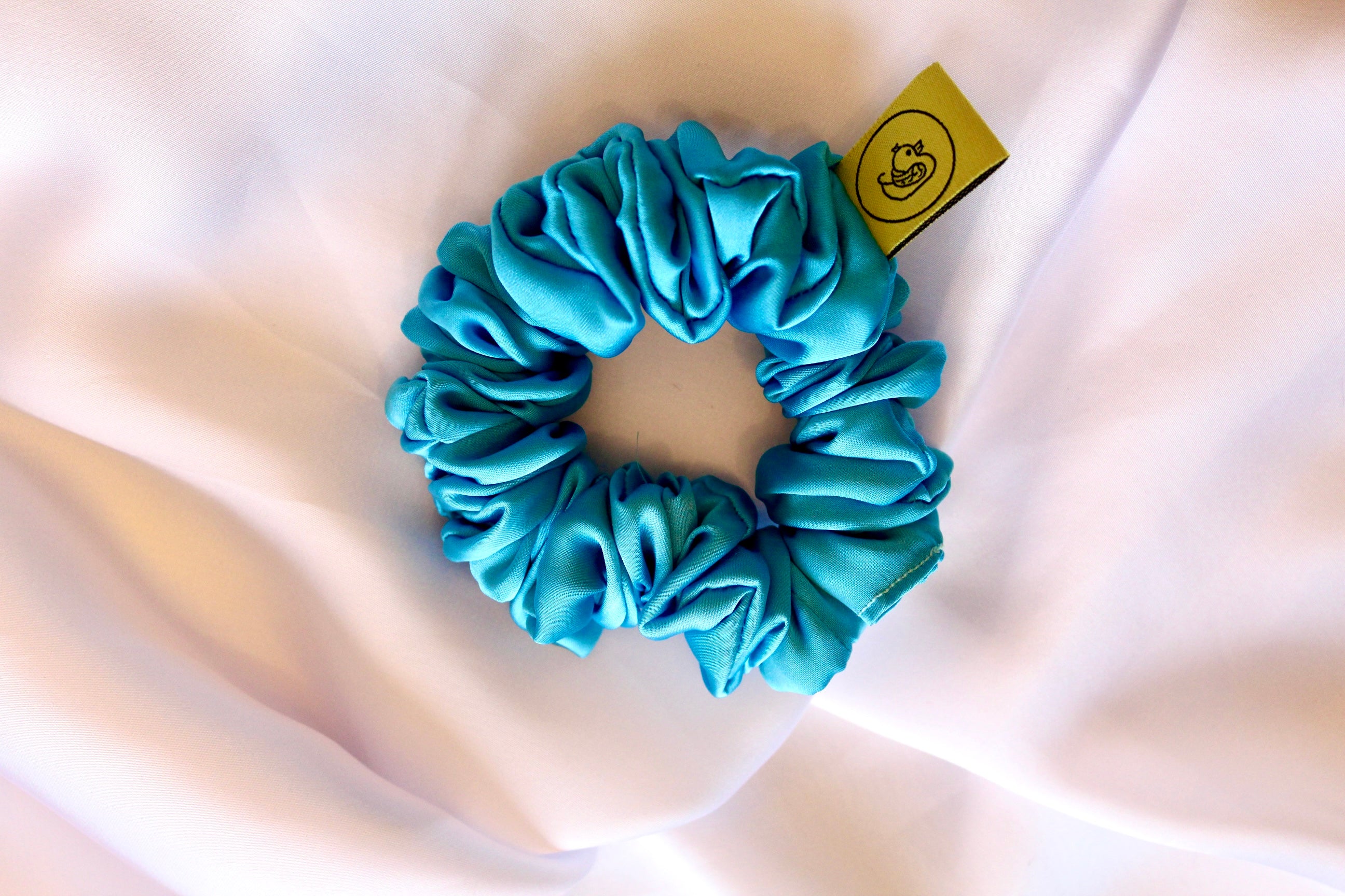 This is a luxurious Turquoise satin hair scrunchie they are perfect for any elegant hairstyle,they will hold your hair in place without pulling on your roots preventing hair loss.Making them perfect for anyone who has a sensitive scalp or chronic illness.