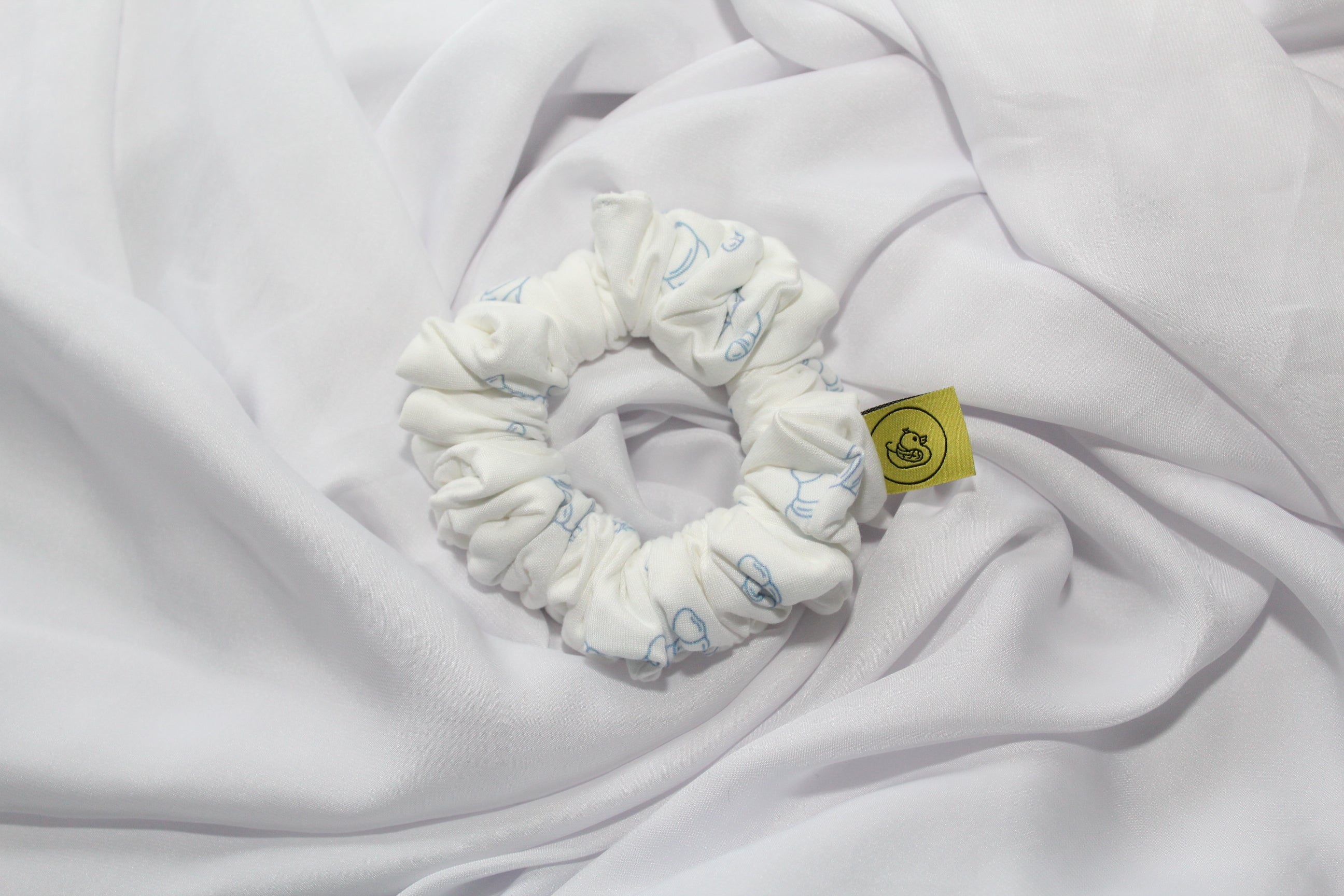 Handmade breakfast themed scrunchie pastel colours UK

Cute food inspired scrunchie handmade UK

Breakfast club hair scrunchie for ponytail styling

White Soft scrunchie with pastel blue Croissants